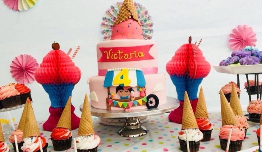 Themed birthday dessert table with matching cake and cupcakes
